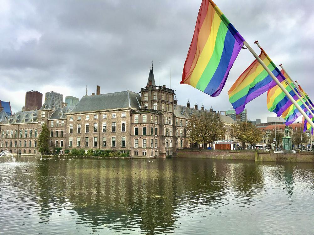 Coming-Out Day 2020 in The Hague. Rainbow flags at the Hofvijver lake next to the buildings of the national parliament of the Netherlands.