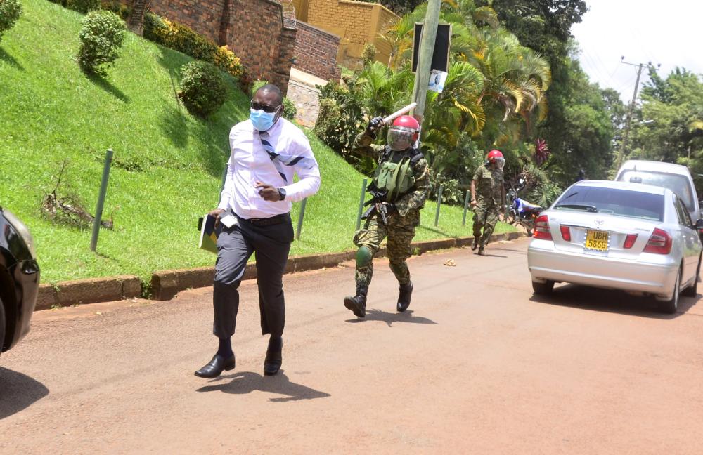 A Ugandan Military police officer Enforcing Covid19 rules chasing a journalist who was covering Bobi Wine when he had taken a petition to the UN human rights Kampala office protesting continued human rights violations and the illegal detention of his supporters.