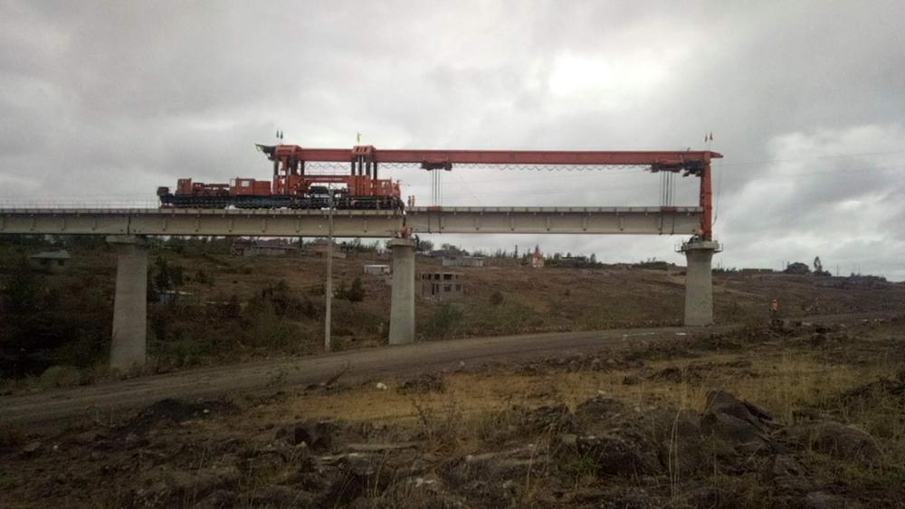 A heavy-duty crane is laying off overhead passage for SGR train, Kajiado Kenya